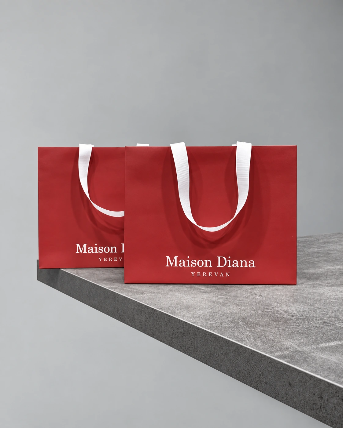 Maison Diana Yerevan-ի երկու կարմիր տոպրակները՝ սպիտակ բռնակներով